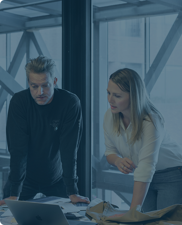 Two people collaborating on a laptop